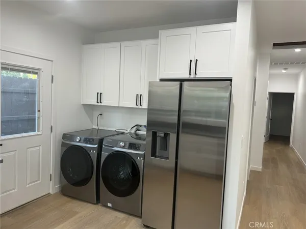 a kitchen with a refrigerator and cabinets