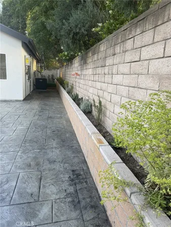 a view of a pathway with a wooden fence