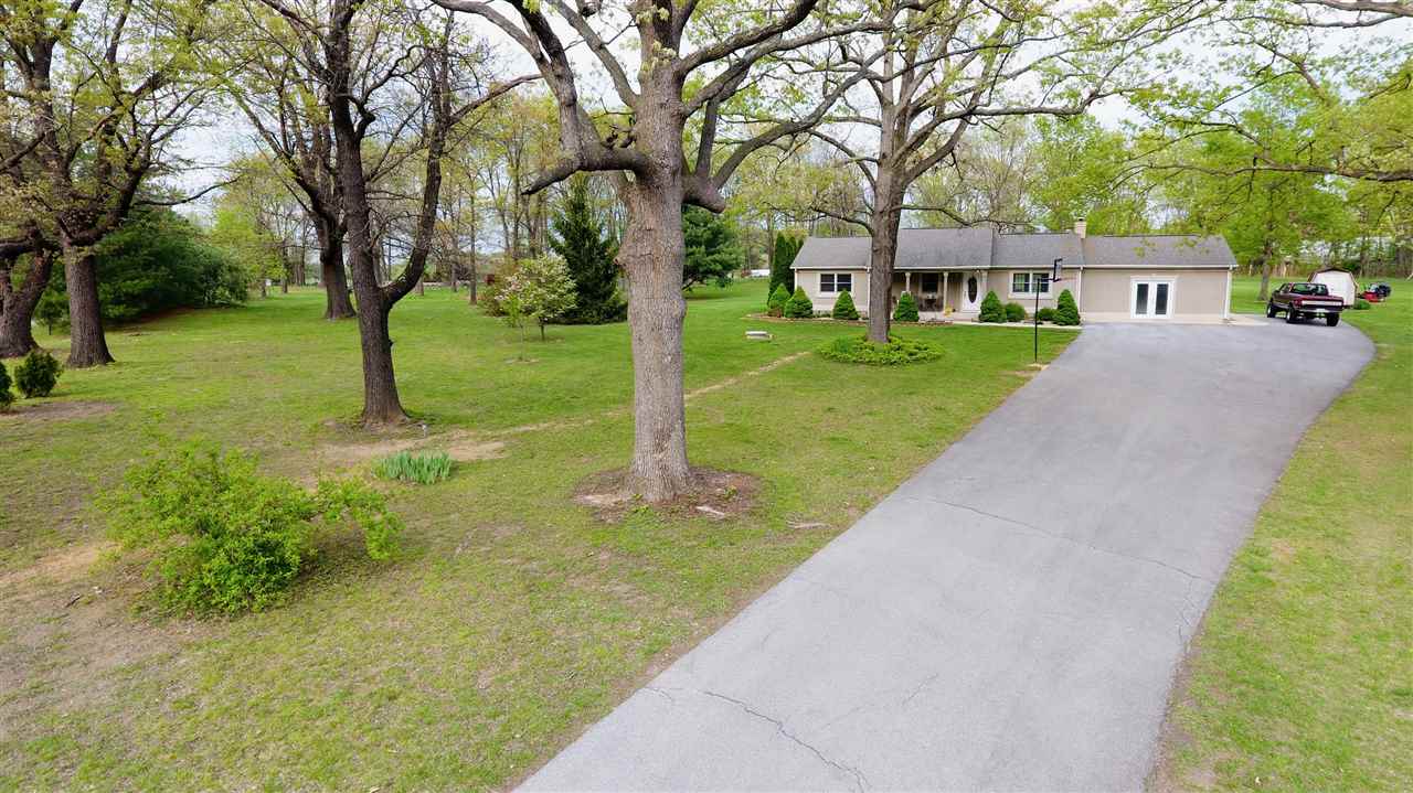 a view of house with a yard