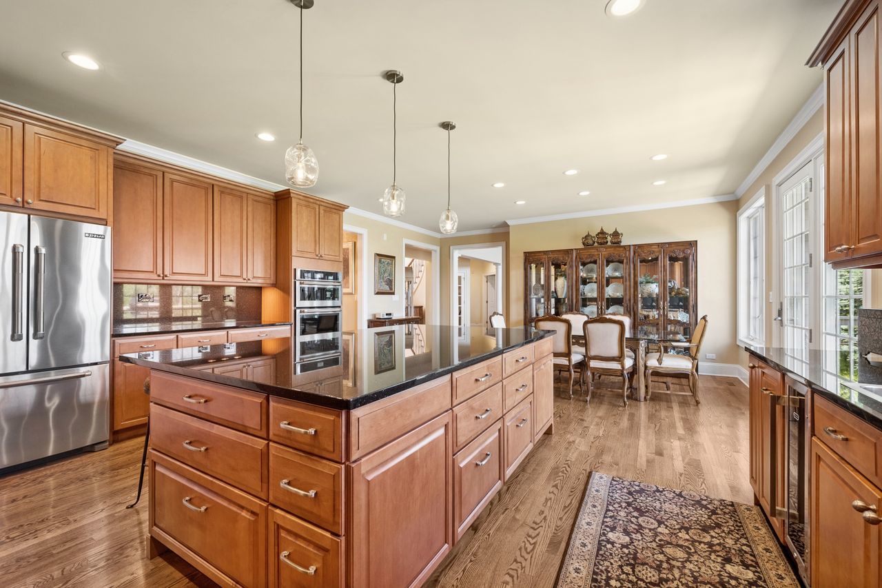 1029 Ridgeview Drive Inverness, IL 60010 - Photo 17 of 58 a kitchen with stainless steel appliances granite countertop a refrigerator and a wooden floor