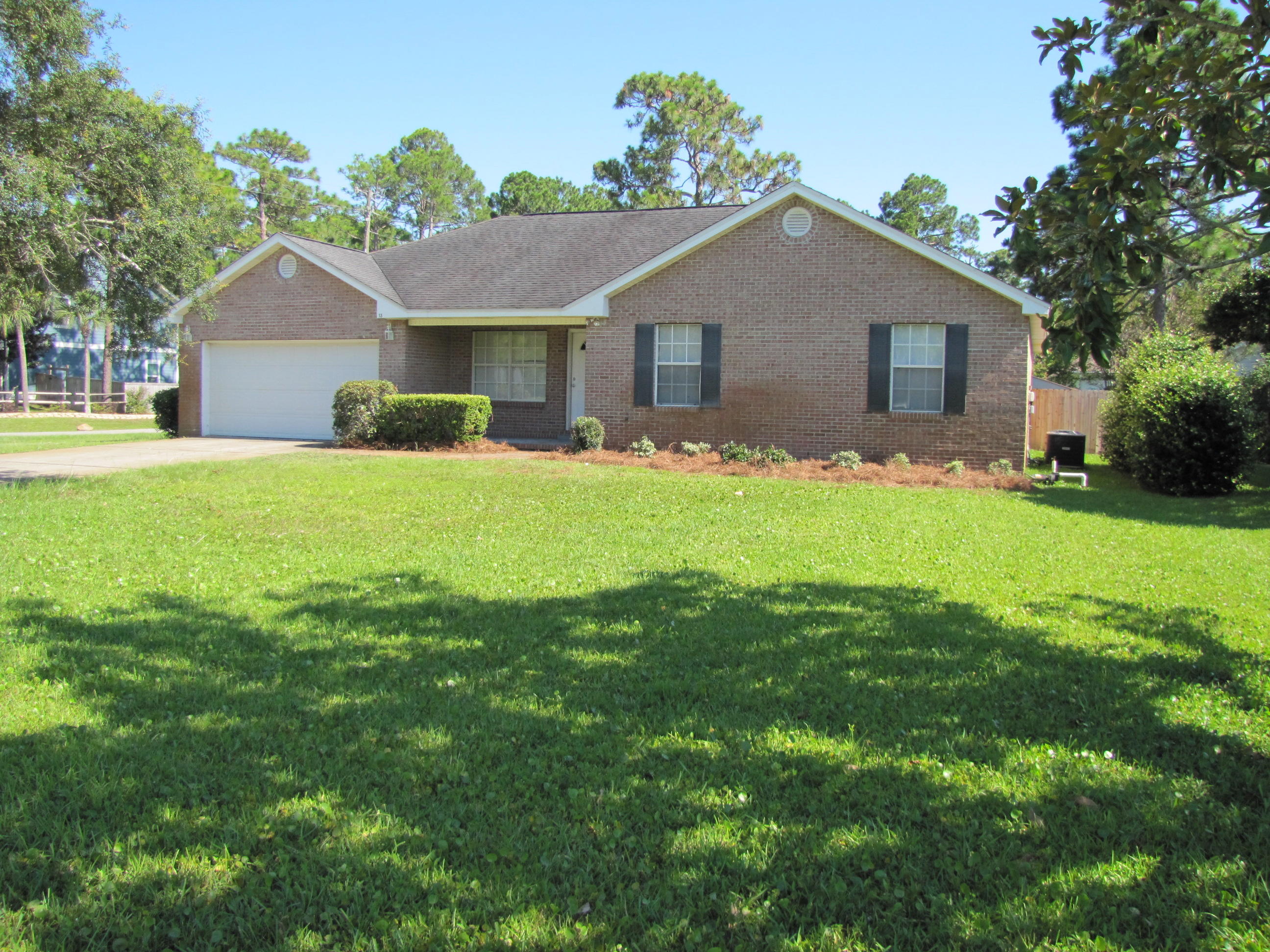 13 Initial Lane Santa Rosa Beach, FL 32459 - Photo 1 of 24 a front view of house with yard and green space