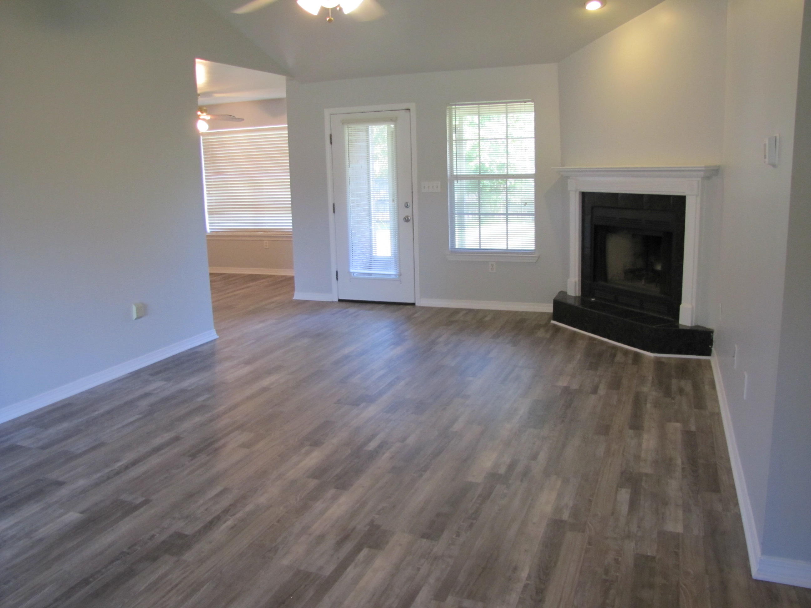 13 Initial Lane Santa Rosa Beach, FL 32459 - Photo 2 of 24 an empty room with wooden floor fireplace and windows