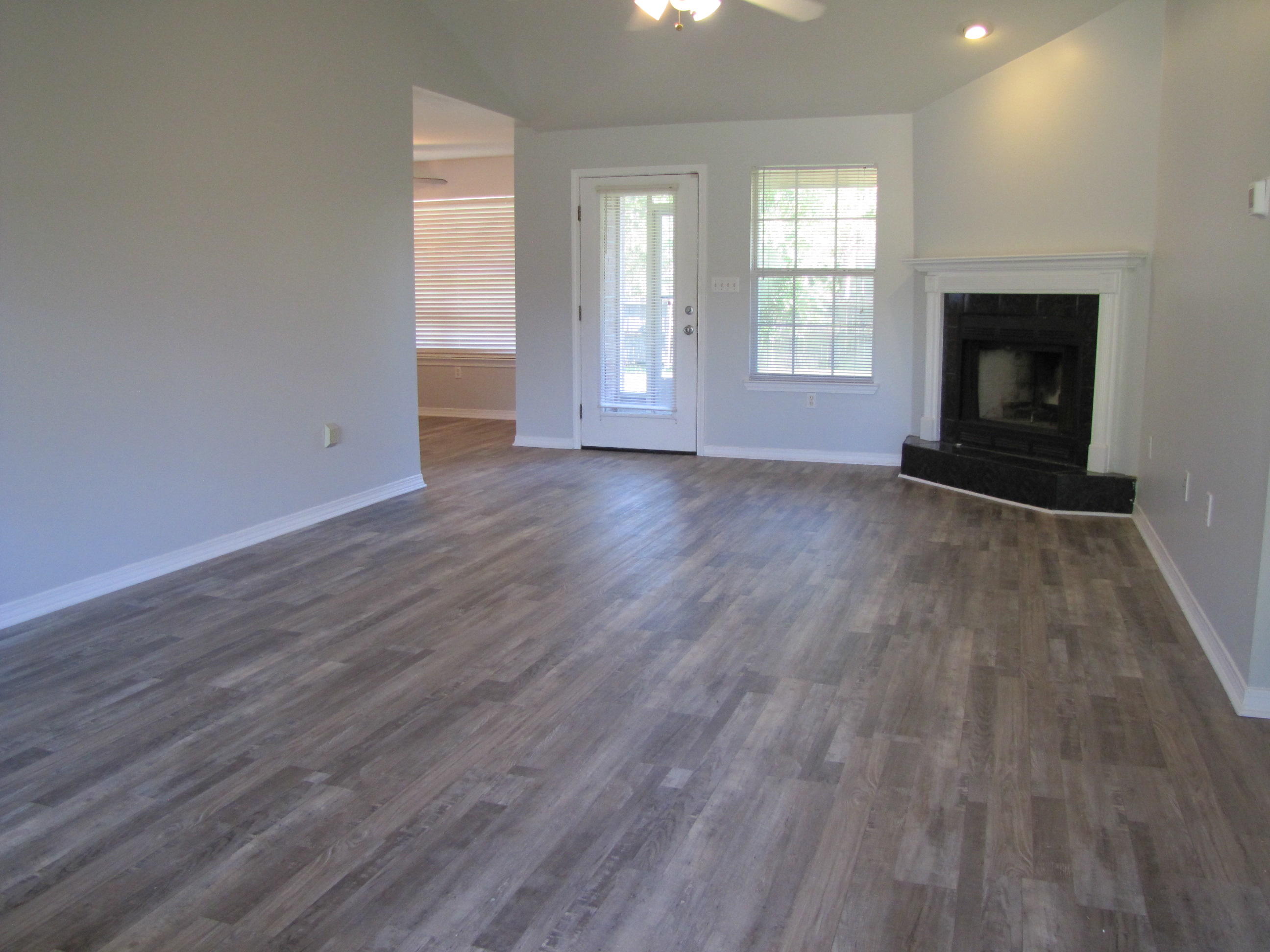 13 Initial Lane Santa Rosa Beach, FL 32459 - Photo 3 of 24 an empty room with wooden floor fire place and windows