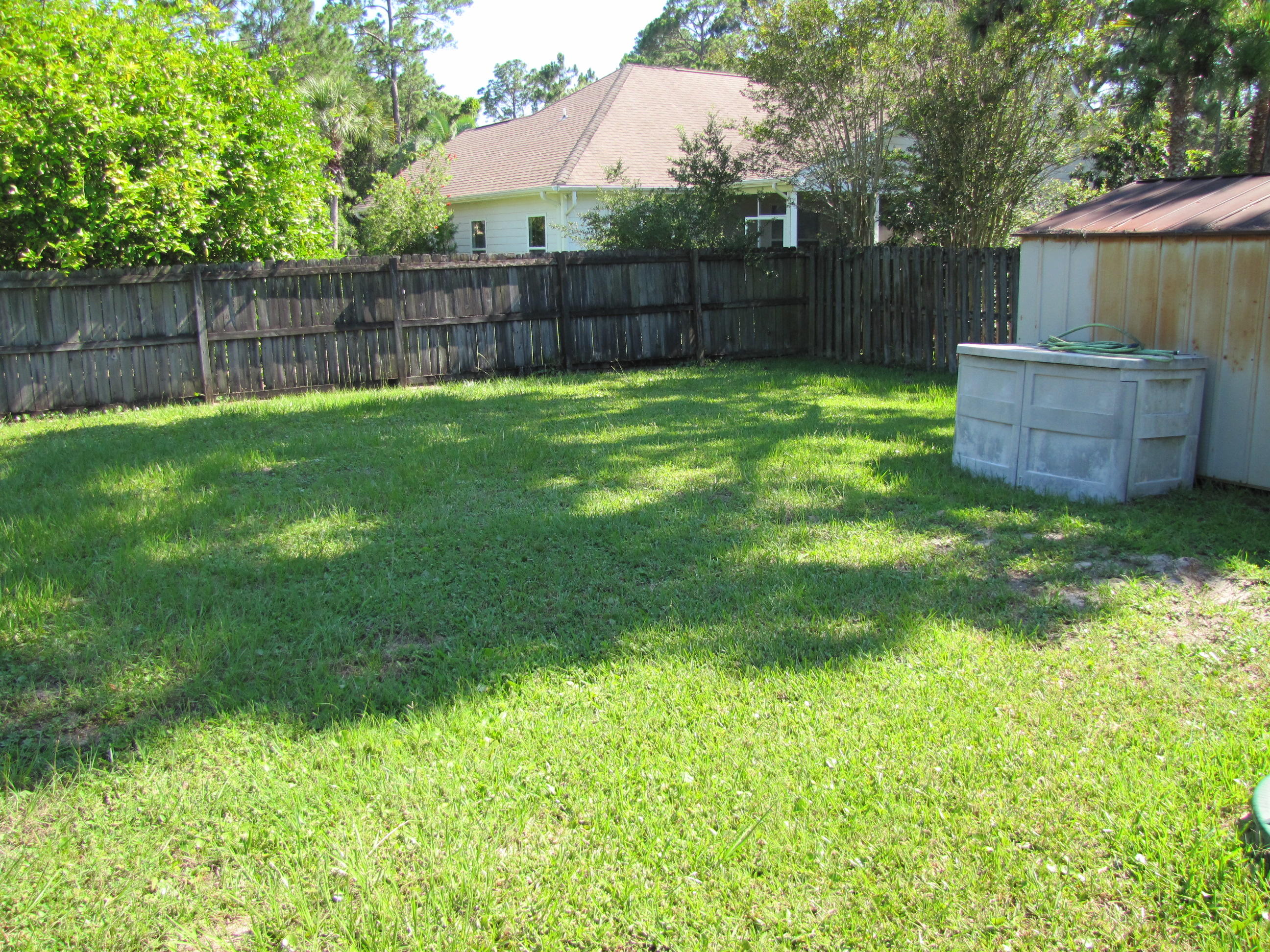 13 Initial Lane Santa Rosa Beach, FL 32459 - Photo 9 of 24 a view of a backyard with a small cabin and a chair