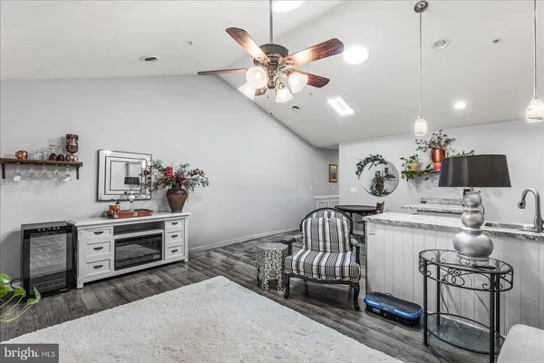 a kitchen with stainless steel appliances a dining table and chairs