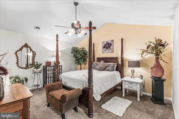 a bedroom with a bed dresser and window