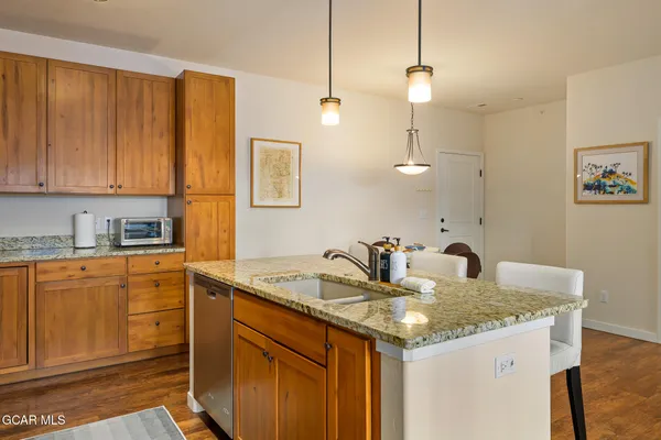 a kitchen with a sink a counter space and cabinets