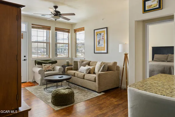 a living room with furniture and a chandelier