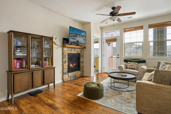 a living room with furniture a window and a fireplace