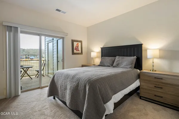 a bedroom with a bed and large window