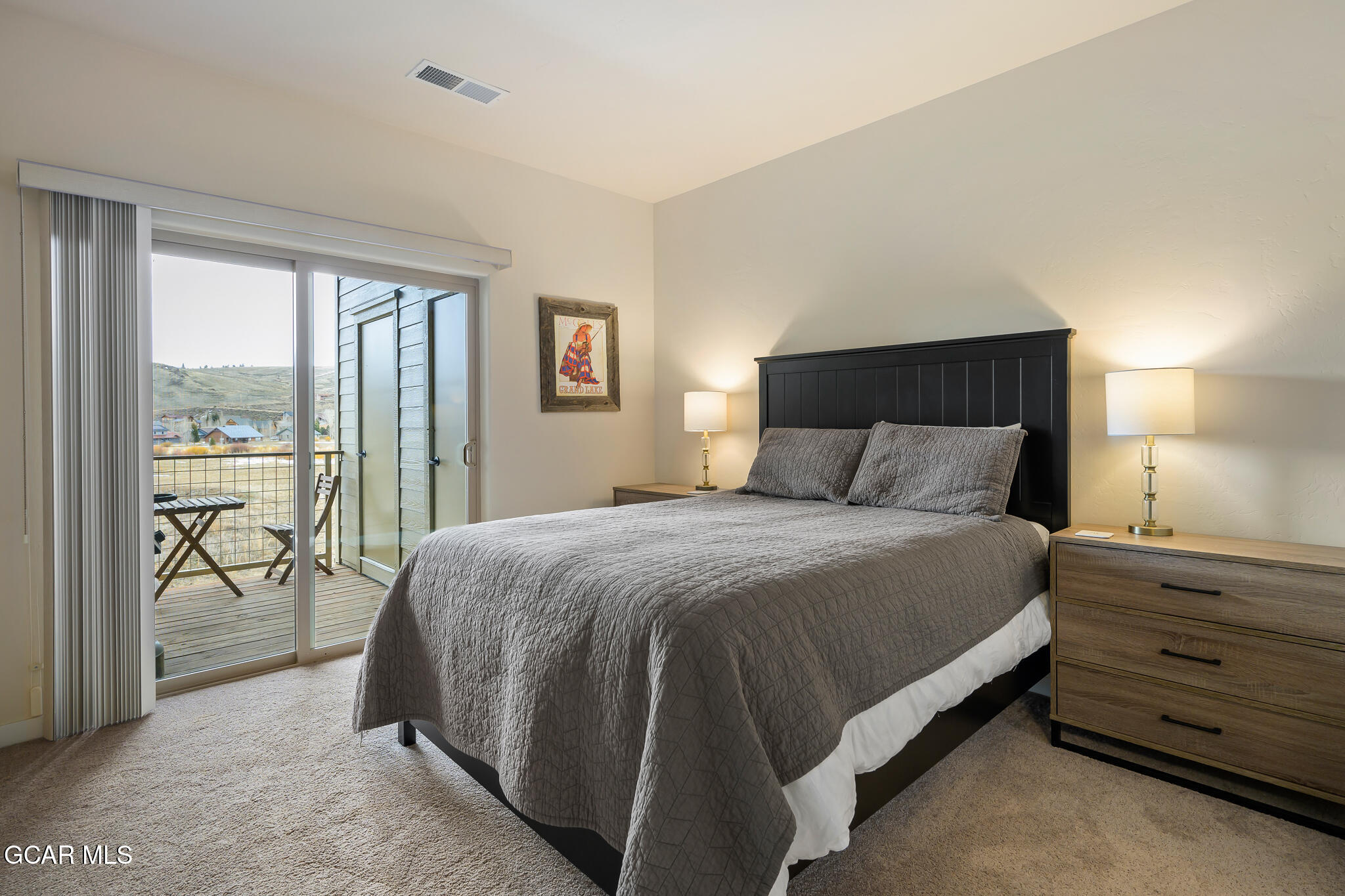 164 Village Road, Unit H203 Granby, CO 80446 - Photo 24 of 38 a bedroom with a bed and large window