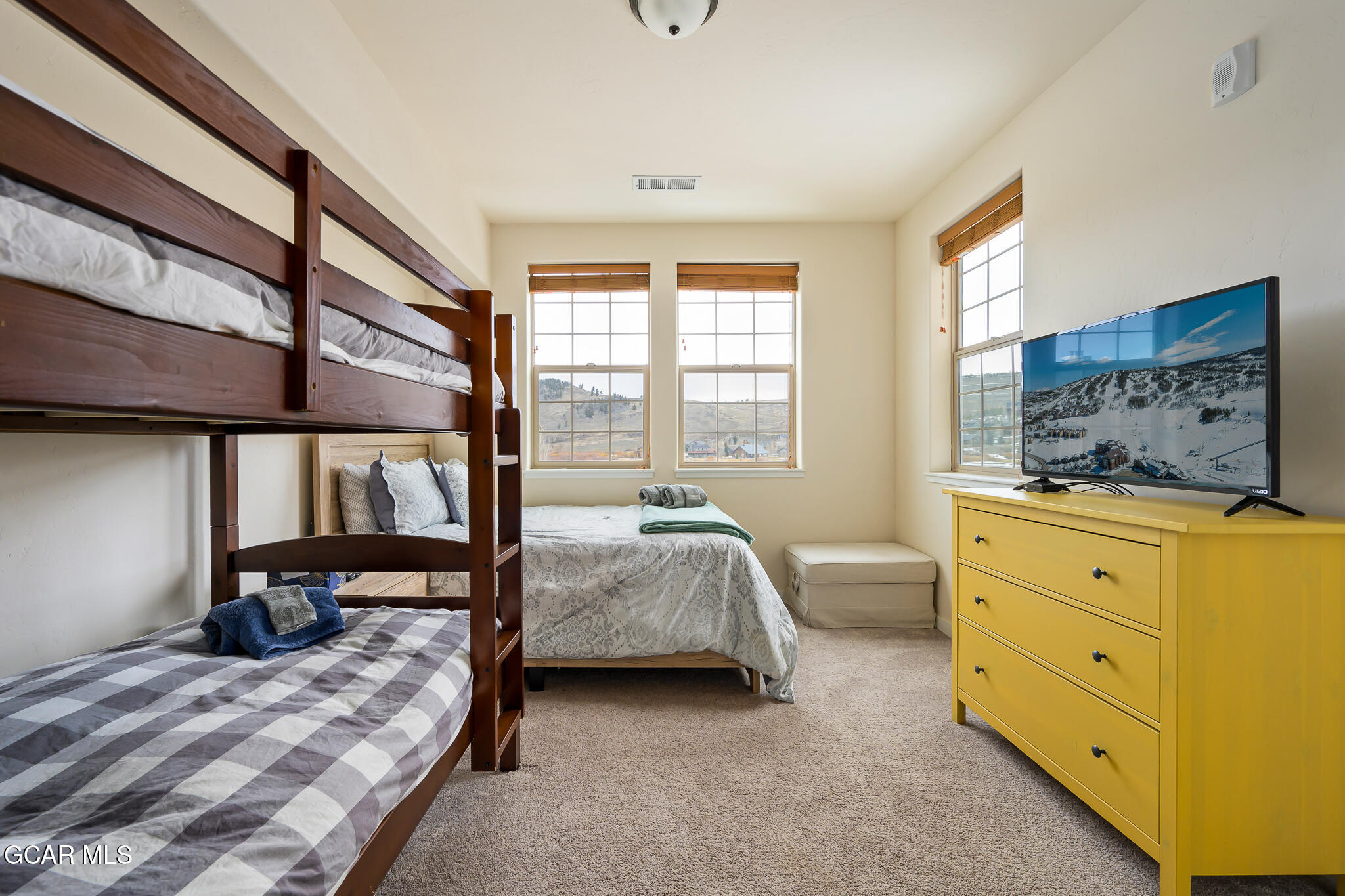 164 Village Road, Unit H203 Granby, CO 80446 - Photo 26 of 38 a bedroom with a bed and large windows