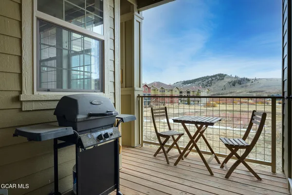 a view of a balcony with chairs and a table