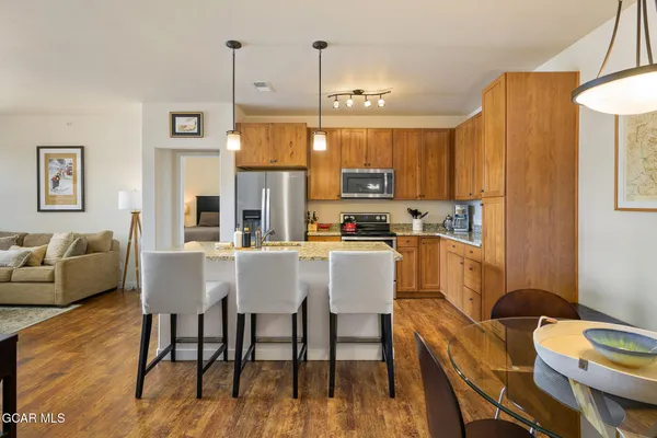 a kitchen with a table chairs refrigerator and cabinets