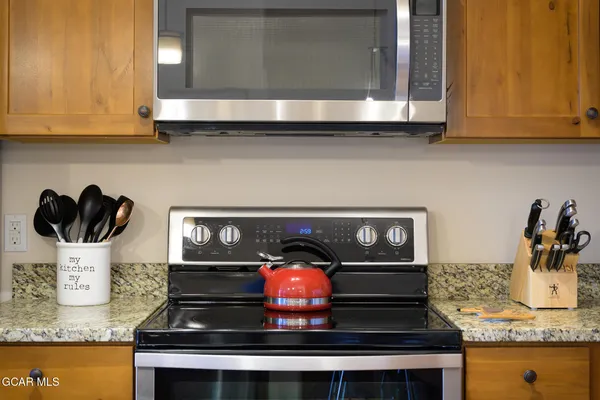 a stove top oven sitting inside of a kitchen