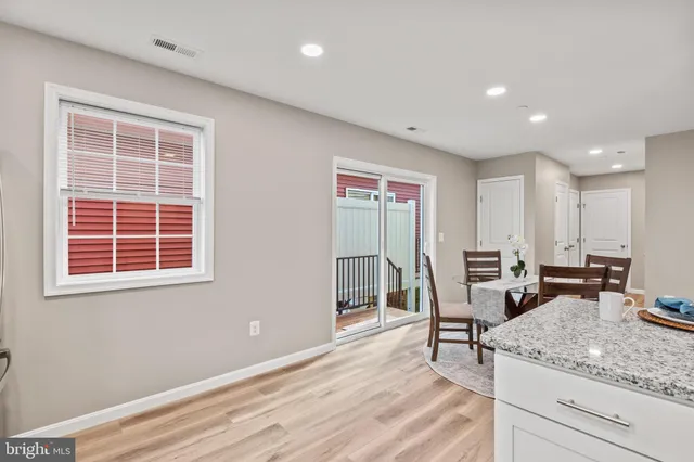 a view of kitchen with granite countertop window and chairs
