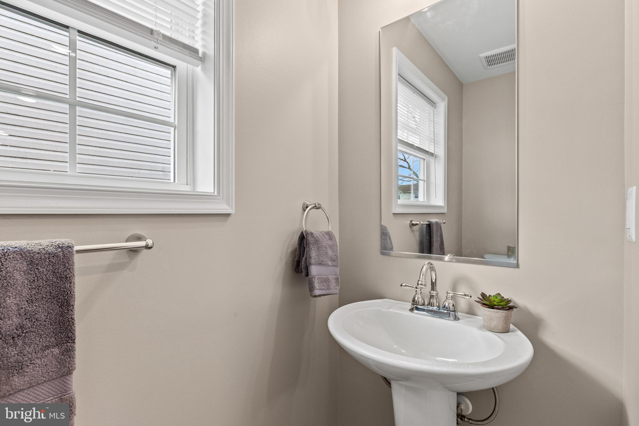 22802 Lawrence Avenue Leonardtown, MD 20650 - Photo 12 of 28 a bathroom with a sink a mirror and a window