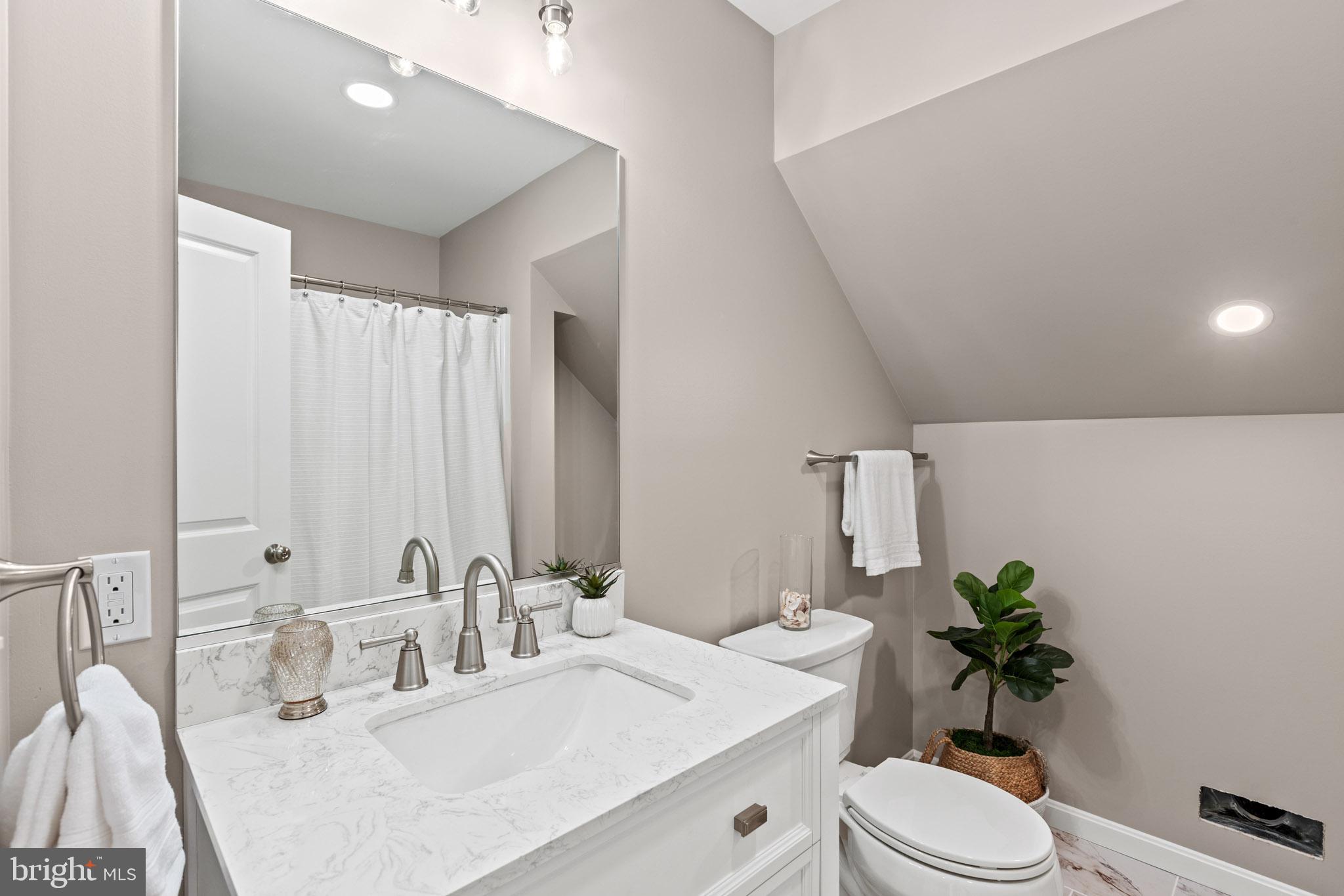 22802 Lawrence Avenue Leonardtown, MD 20650 - Photo 16 of 28 a bathroom with a double vanity sink toilet and a mirror