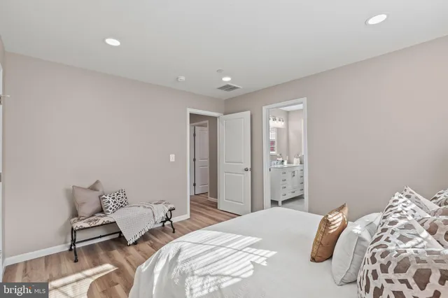 a bedroom with a bed and a couch