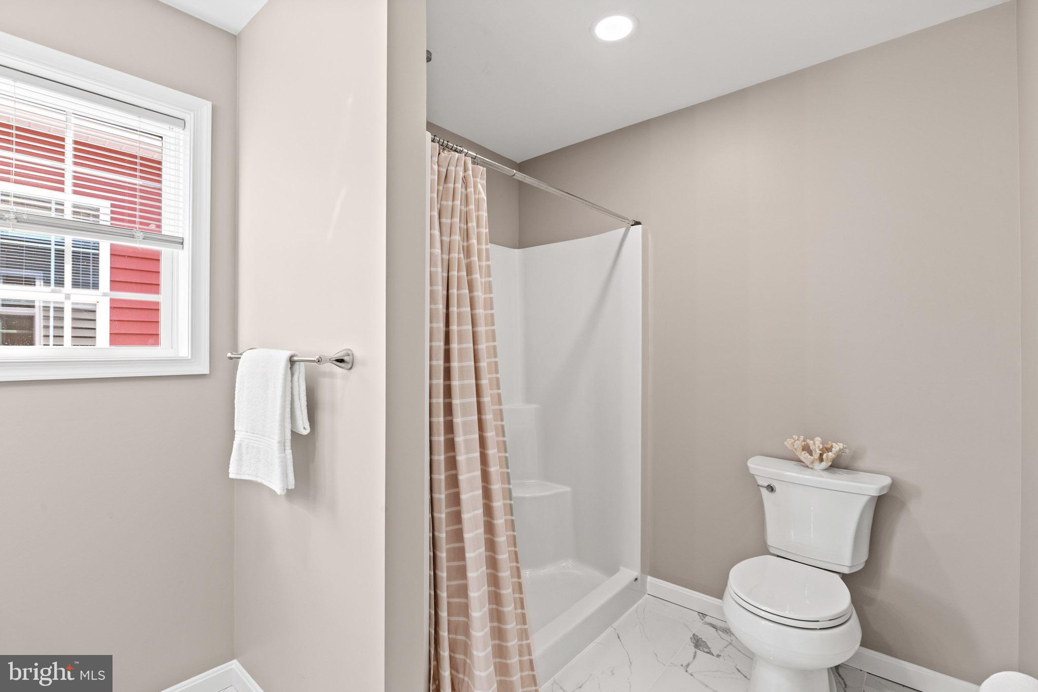 22802 Lawrence Avenue Leonardtown, MD 20650 - Photo 26 of 28 a bathroom with a toilet and a shower