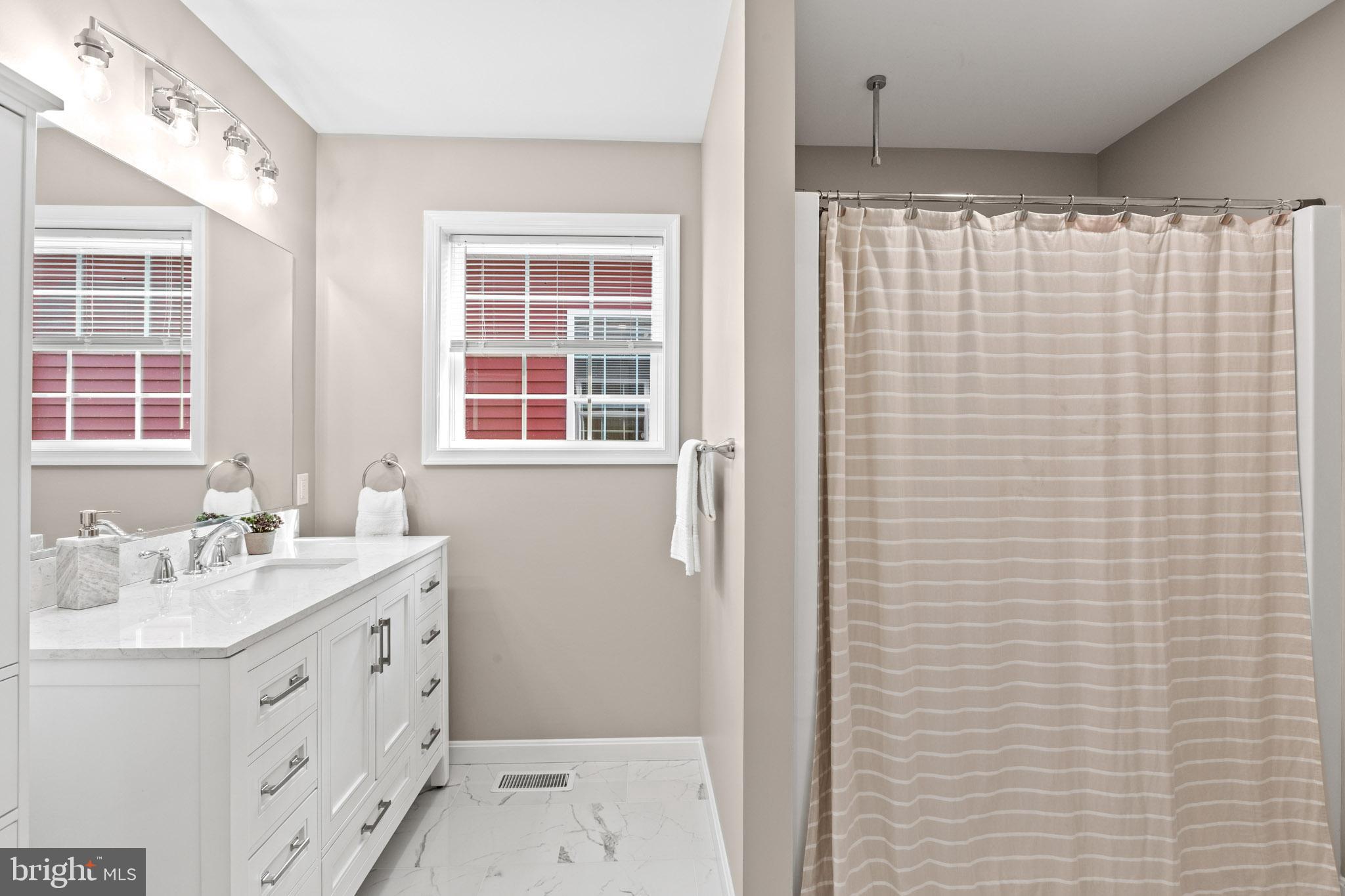 22802 Lawrence Avenue Leonardtown, MD 20650 - Photo 27 of 28 a bathroom with a sink a vanity and a shower
