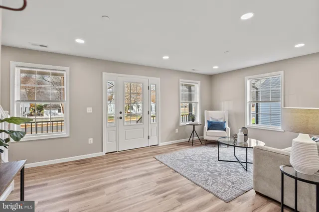 a living room with furniture and wooden floor