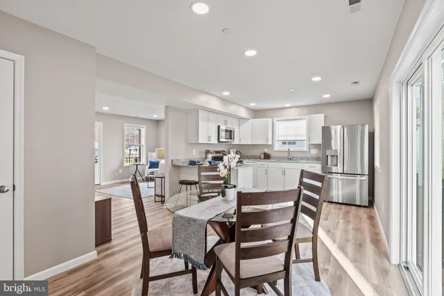a view of a dining room with furniture and wooden floor