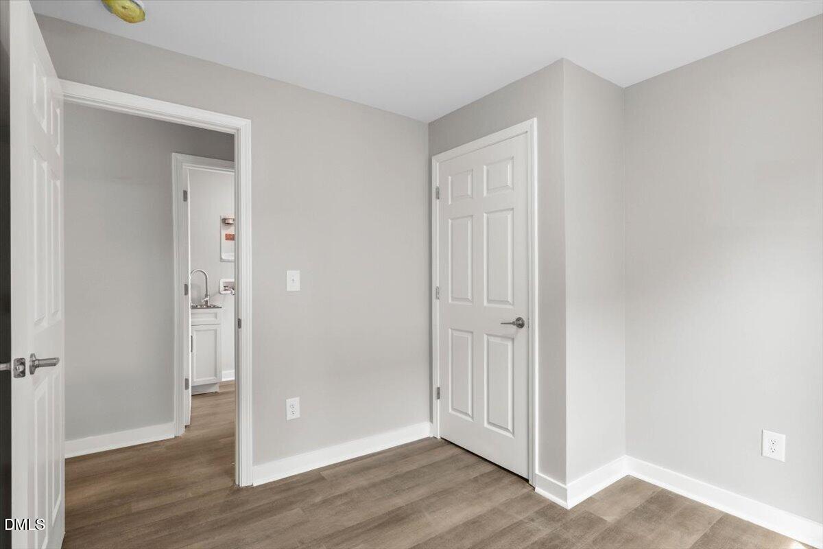 509 Sparella Street Durham, NC 27703 - Photo 26 of 30 an empty room with wooden floor & closet area