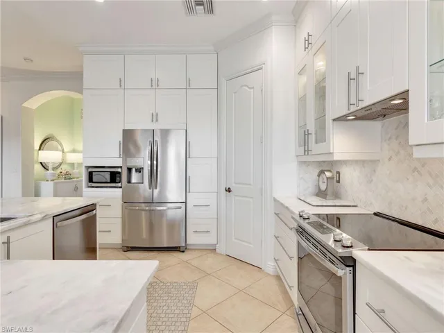 a kitchen with a sink appliances and cabinets