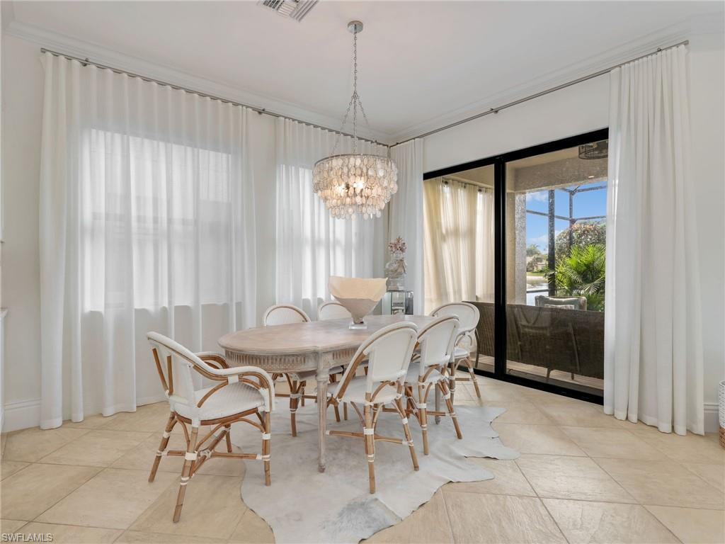 1365 Serrano Circle Naples, FL 34105 - Photo 15 of 46 Dining room featuring plenty of natural light, crown molding, a chandelier, and light tile patterned floors