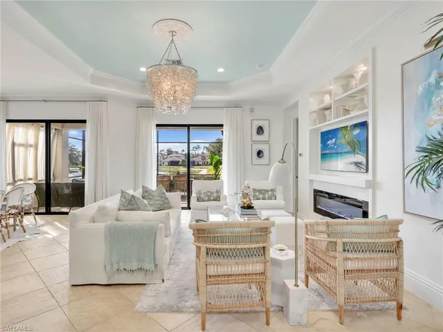 a living room with fireplace furniture and a chandelier