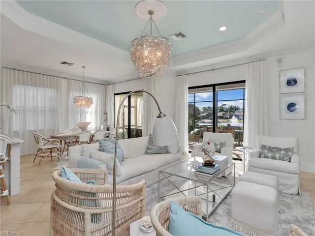 a dining room with furniture a chandelier and a floor to ceiling window