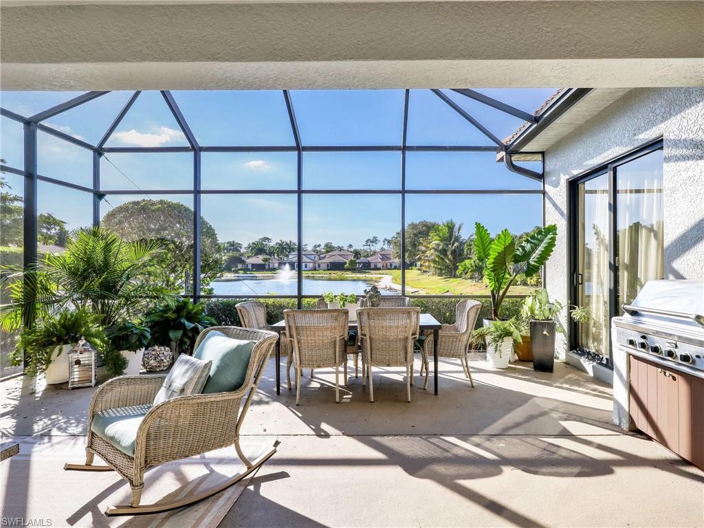 1365 Serrano Circle Naples, FL 34105 - Photo 21 of 46 View of patio / terrace featuring a sunroom, a water view, outdoor dining space, glass enclosure, and area for grilling
