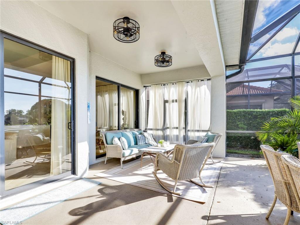 1365 Serrano Circle Naples, FL 34105 - Photo 22 of 46 Sunroom featuring healthy amount of natural light and unfinished concrete floors