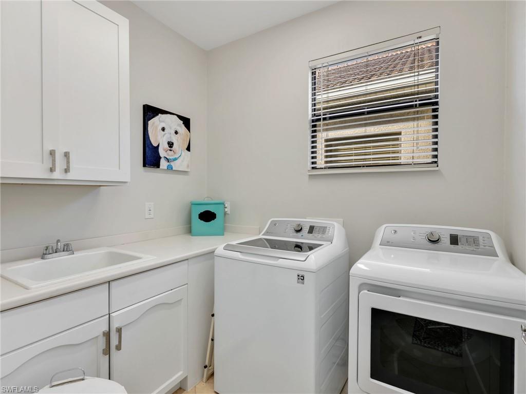1365 Serrano Circle Naples, FL 34105 - Photo 32 of 46 Washroom with washing machine and clothes dryer and cabinet space