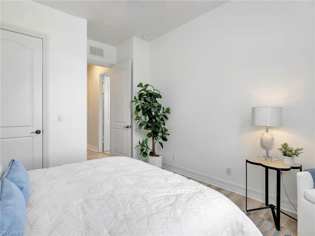1365 Serrano Circle Naples, FL 34105 - Photo 37 of 46 Bedroom featuring light wood-style flooring and baseboards