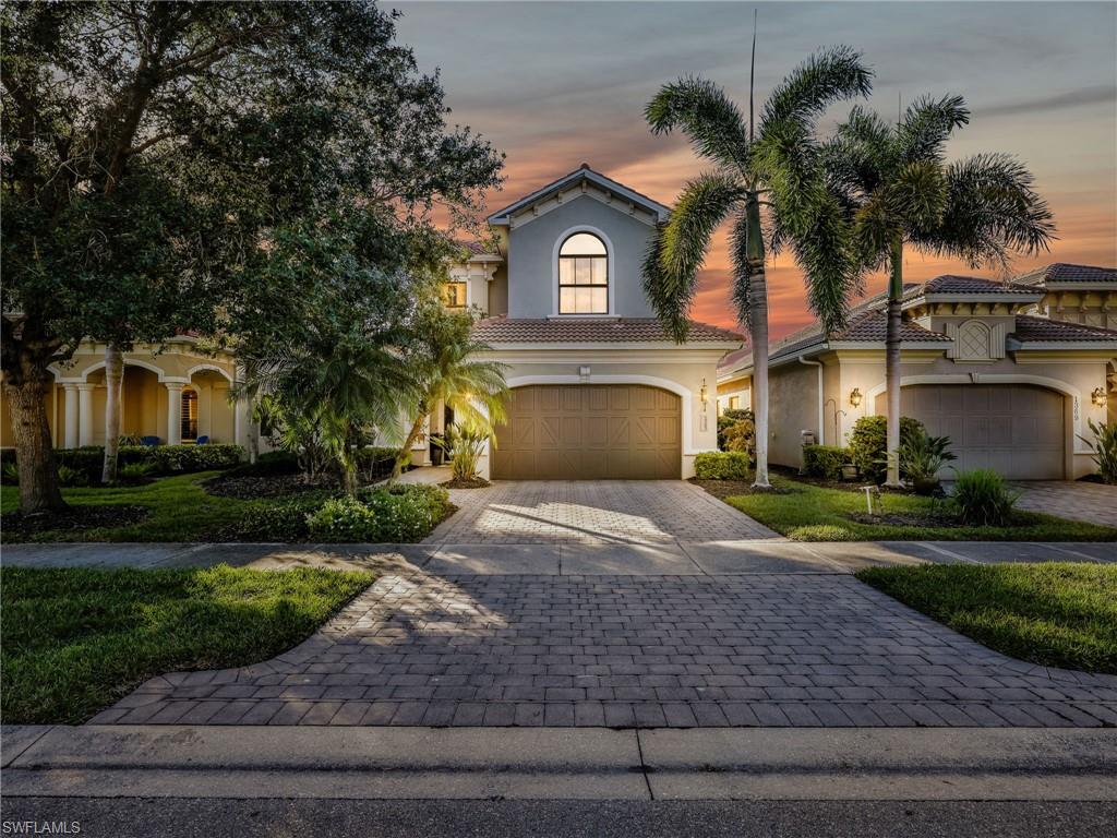 1365 Serrano Circle Naples, FL 34105 - Photo 46 of 46 Mediterranean / spanish-style home with stucco siding, decorative driveway, an attached garage, and a tiled roof