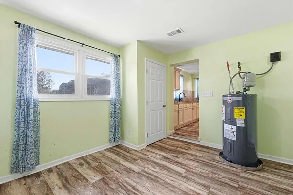 a view of empty room with wooden floor and windows