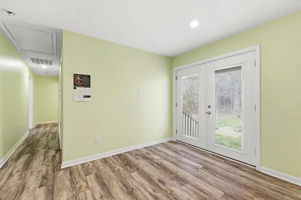 a view of a room with wooden floor and doors