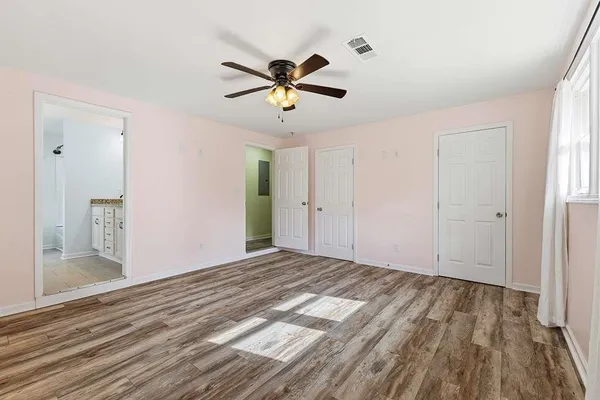 a view of empty room with wooden floor