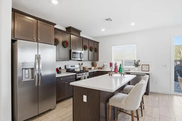 a kitchen with stainless steel appliances a refrigerator sink and stove