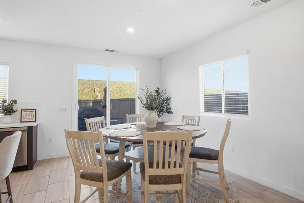a dining room with furniture and window