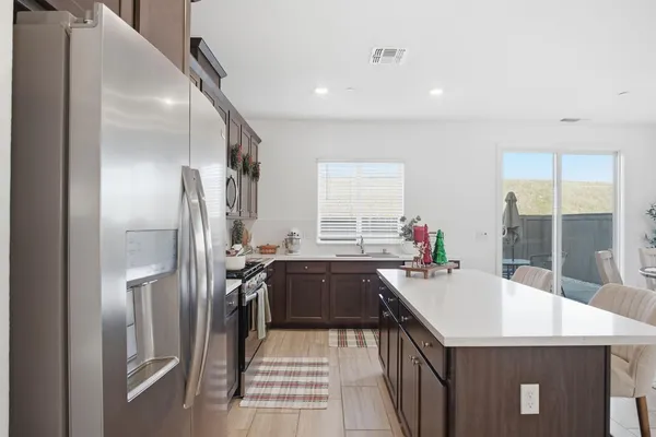 a kitchen with a sink stove and refrigerator