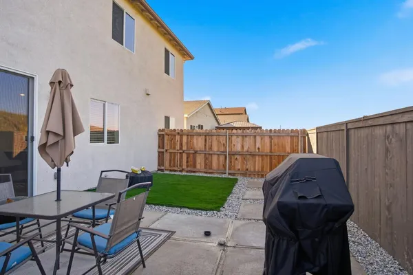 a view of backyard with a patio and outdoor seating