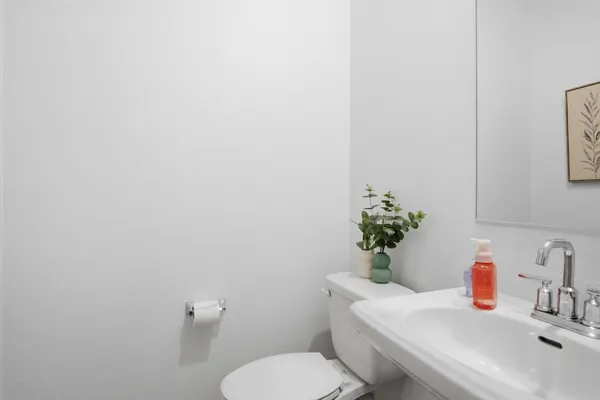 a bathroom with a sink a toilet and a mirror