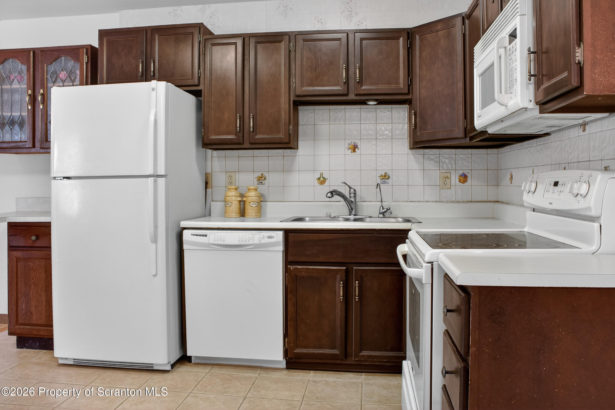 211 Falls Circle Bushkill, PA 18324 - Photo 4 of 28 a kitchen with a sink a refrigerator and cabinets