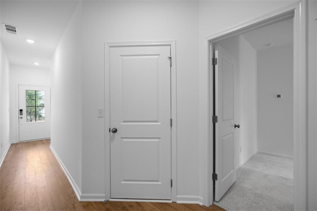 1701 Lansmere Street Southwest Marietta, GA 30008 - Photo 13 of 29 a view of a hallway with wooden floor and a bathroom