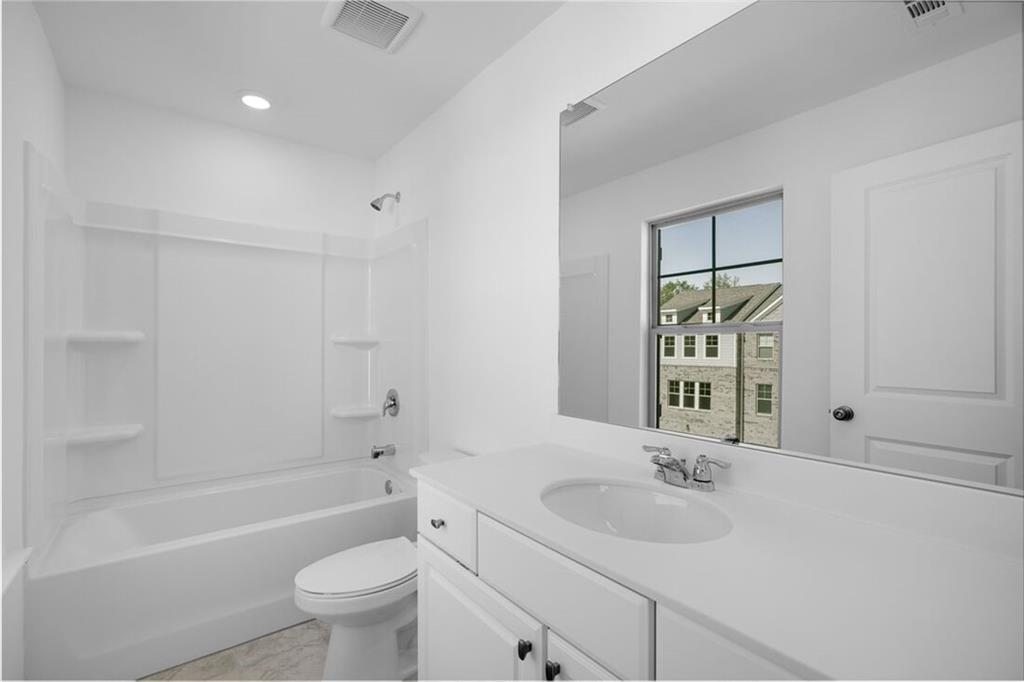 1701 Lansmere Street Southwest Marietta, GA 30008 - Photo 5 of 29 a bathroom with a sink toilet tub and shower