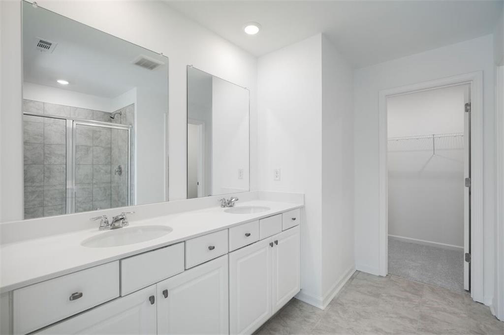 1701 Lansmere Street Southwest Marietta, GA 30008 - Photo 7 of 29 a bathroom with double sink and a mirror