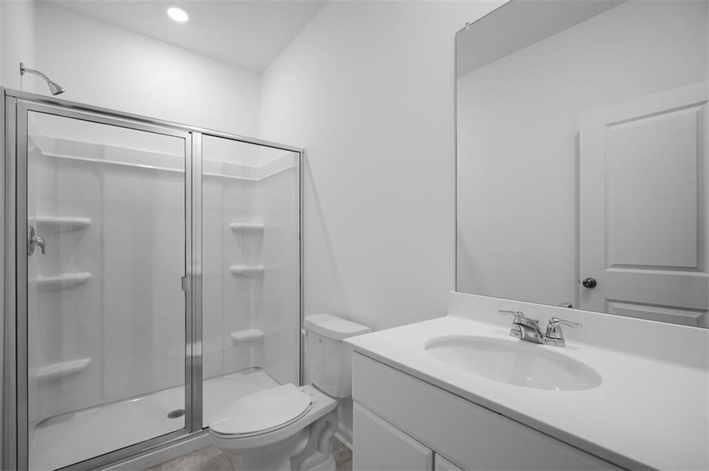 1701 Lansmere Street Southwest Marietta, GA 30008 - Photo 9 of 29 a bathroom with a sink a toilet and shower